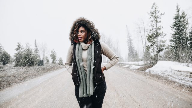 Woman Standing In Middle of Road in Snowy Weather