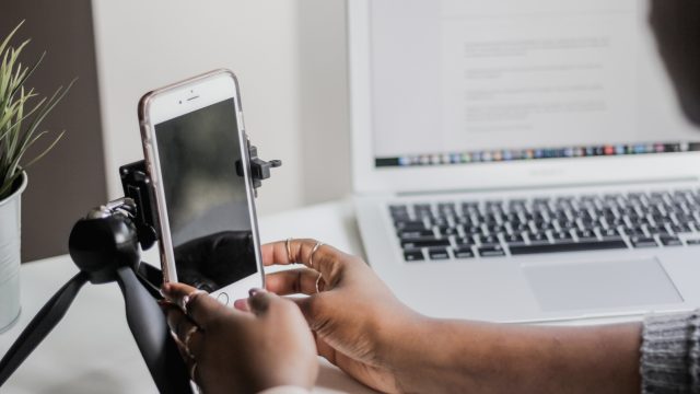 Woman with Phone on Mini Tripod